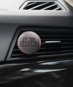 Smell Crusher car freshener clipped to a car air vent