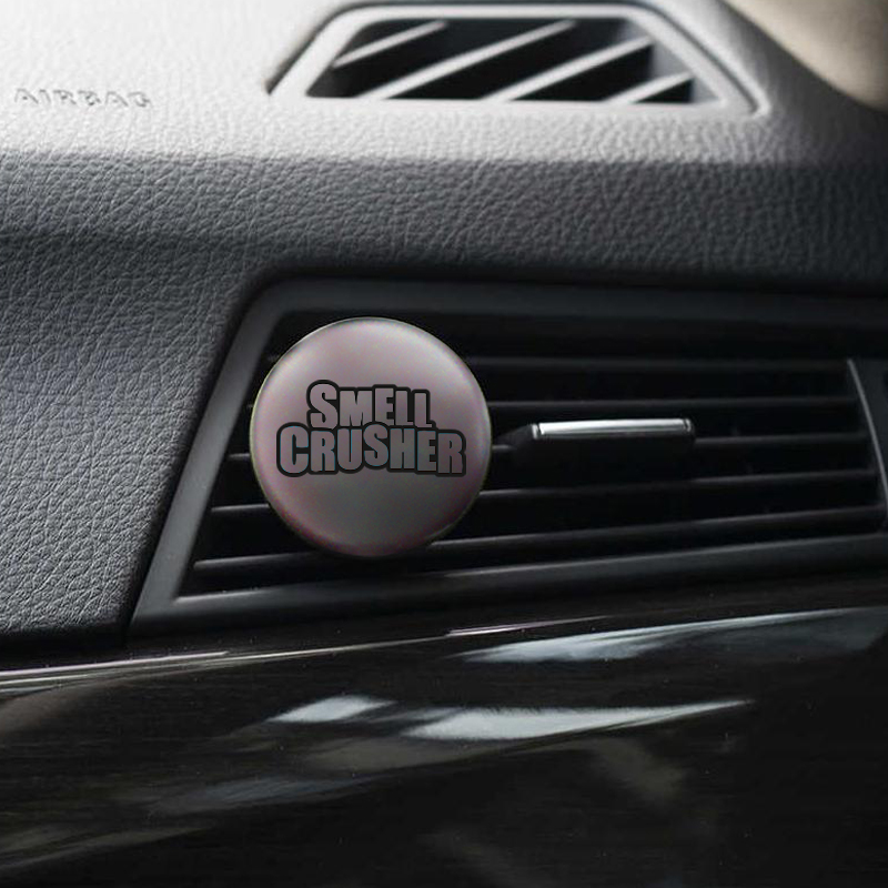 Smell Crusher car freshener clipped to a car air vent