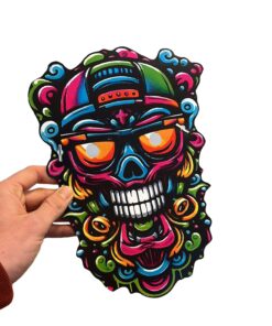Smell Crusher skull mask with the colourful graffiti skull artwork, held in hand